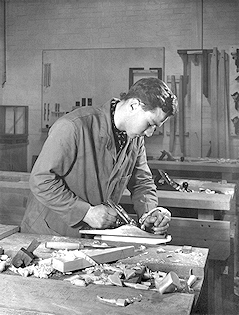 Carpentry student uses a plane
