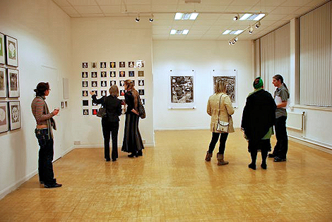 Six people look at art