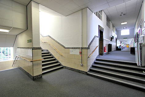 Photo of a corridor, with sets of stairs on the left