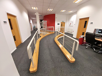 Corridor with sloping up floor section in middle