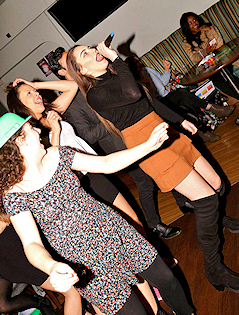 three girls singing and dancing