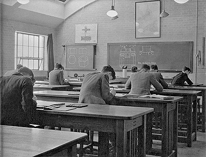 Young lads sitting at desks, viewed from behind