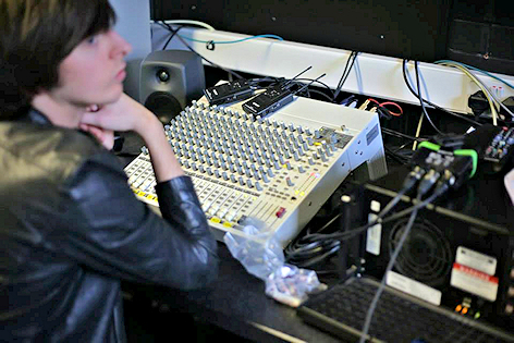 Student monitors sound in the TV studio gallery