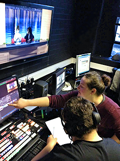 Two students in the TV control room gallery